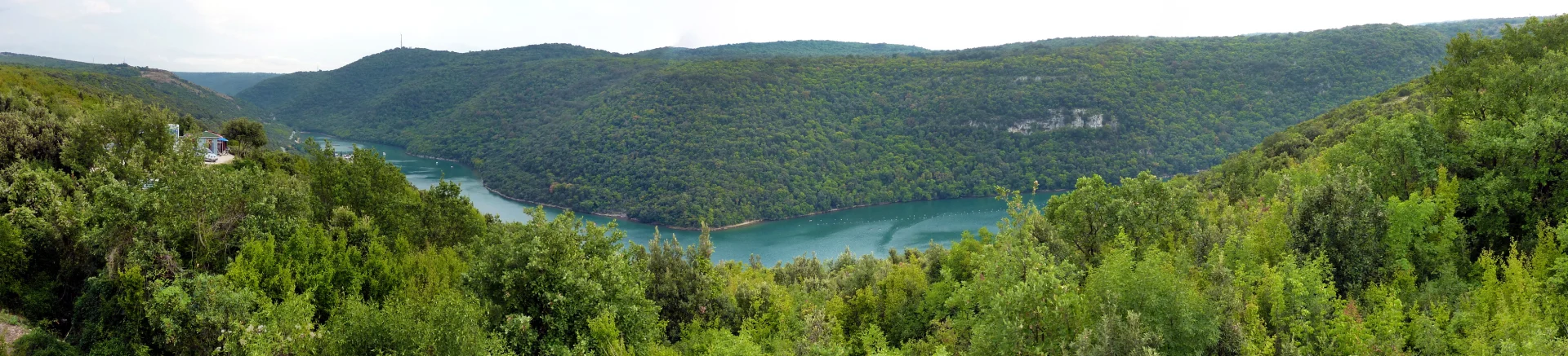 A panorama of Lim Bay and its wooded shores